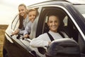 Happy smiling mother and children are traveling together in their modern family car Royalty Free Stock Photo