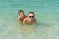 Happy smiling mother and her son playing and running on the beach. Concept of friendly family - Image Royalty Free Stock Photo