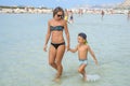 Happy smiling mother and her son playing and running on the beach. Concept of friendly family. Happy summer days. Balos Lagoon Royalty Free Stock Photo