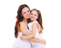 Happy smiling mother hugging little child daughter on white