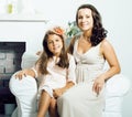 Happy smiling mother with little cute daughter at home interior, casual look modern real family, lifestyle people