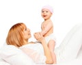 Happy smiling mother playing with baby on bed Royalty Free Stock Photo