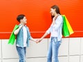 Happy smiling mother and son child with shopping bags having fun in city Royalty Free Stock Photo