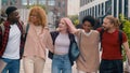 Happy smiling multiracial students diverse multiethnic diversity friends walking in city university college campus Royalty Free Stock Photo