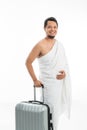 Happy smiling muslim male with suitcase going for hajj