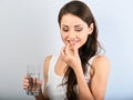 Happy smiling natural positive woman holding the vitamin E capsule in the hand and glass of pure water. Closeup Royalty Free Stock Photo