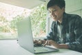 Happy smiling People of man short hair using laptop  working at home sitting on the chair Royalty Free Stock Photo