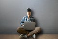 Happy smiling People of woman short hair using laptop  working at home sitting on the floor Royalty Free Stock Photo