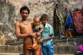 Happy smiling poor family bathing near the Banganga slum