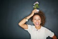 Happy, smiling and portrait of a black woman with plant isolated on a black background in studio. Cheerful, funny and Royalty Free Stock Photo