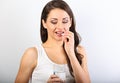 Happy smiling positive woman eating the pill and holding the glass of water in the hand on white background. Closeup portrait Royalty Free Stock Photo