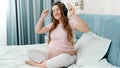 Happy smiling pregnant woman enjoying music and dancing while wearing headphones. Unborn baby listening to classic music Royalty Free Stock Photo