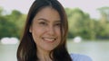 Happy smiling pretty Asian woman with a smile on her face looking at the camera in broad daylight in the park, natural sunlight, Royalty Free Stock Photo