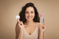 Happy pretty young brunette woman using cotton pads, micellar water Royalty Free Stock Photo