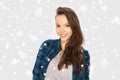 Happy smiling pretty teenage girl over snow Royalty Free Stock Photo