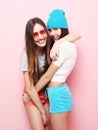 Happy smiling pretty teenage girls or friends hugging over pink Royalty Free Stock Photo