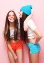 Happy smiling pretty teenage girls or friends hugging over pink Royalty Free Stock Photo
