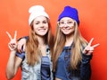 happy smiling pretty teenage girls or friends hugging and showi Royalty Free Stock Photo