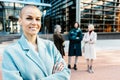 Happy smiling professional manager woman with crossed arms standing outdoors Royalty Free Stock Photo