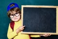 Happy smiling pupils drawing at the desk. Cheerful smiling child at the blackboard. Classroom. September 1. Back to