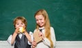 Happy smiling pupils drawing at the desk. Elementary school kids in classroom at school. Teacher schoolgirl helping Royalty Free Stock Photo