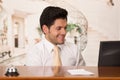 Happy smiling receptionist in hotel looking friendly for the guests in hotel background Royalty Free Stock Photo