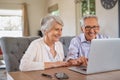 Senior couple using laptop