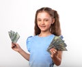 Happy smiling rich kid girl holding money in the hand with natural emotional face on white background Royalty Free Stock Photo