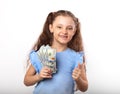 Happy smiling rich kid girl holding money and showing thumb up s Royalty Free Stock Photo