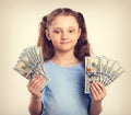 Happy smiling rich kid girl holding money in two hands with calm Royalty Free Stock Photo