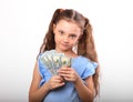 Happy smiling rich kid girl holding money two hands on white background with empty copy space Royalty Free Stock Photo