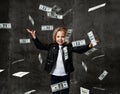 Happy smiling rich kid girl millionaire with a bundle of money dollars cash bills falling down flying from the sky Royalty Free Stock Photo