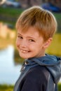 Happy smiling schoolboy with blond hair