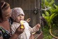 Happy smiling senior grandmother child baby feeding porridge countryside