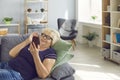 Happy smiling senior woman lying on sofa and talking on video call using phone with family Royalty Free Stock Photo