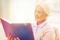 Happy smiling senior woman reading book at home Royalty Free Stock Photo