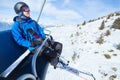 Happy skier on ski lift elevator in winter mountains Royalty Free Stock Photo