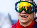 Happy smiling snowboarder in ski mask portrait