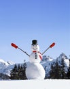 Happy, smiling snowman with mountains in background