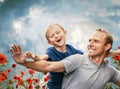 Happy smiling son and father portrait among the poppies