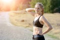 Happy smiling sporty woman enjoys sun after workout outdoors in nature on a sunny day Royalty Free Stock Photo