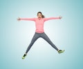 Happy smiling sporty young woman jumping in air Royalty Free Stock Photo