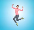 Happy smiling sporty young woman jumping in air Royalty Free Stock Photo