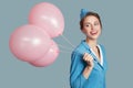 Happy smiling stewardess with pink balloons