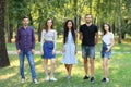 Happy smiling student friends women and men standing together outdoors Royalty Free Stock Photo