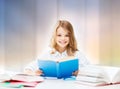 Happy smiling student girl reading book