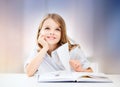 Happy smiling student girl reading book