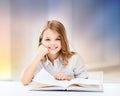 Happy smiling student girl reading book Royalty Free Stock Photo