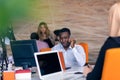 Happy smiling successful African American businessman in in a modern bright startup office indoors Royalty Free Stock Photo
