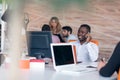 Happy smiling successful African American businessman in in a modern bright startup office indoors Royalty Free Stock Photo